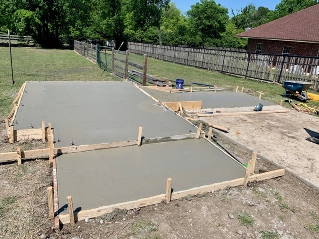 View of freshly poured concrete porch for shed