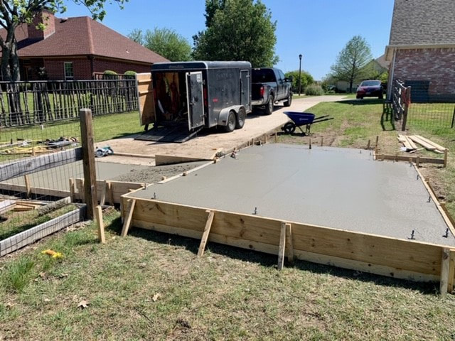 Freshly poured ramp leading to tractor shed foundation