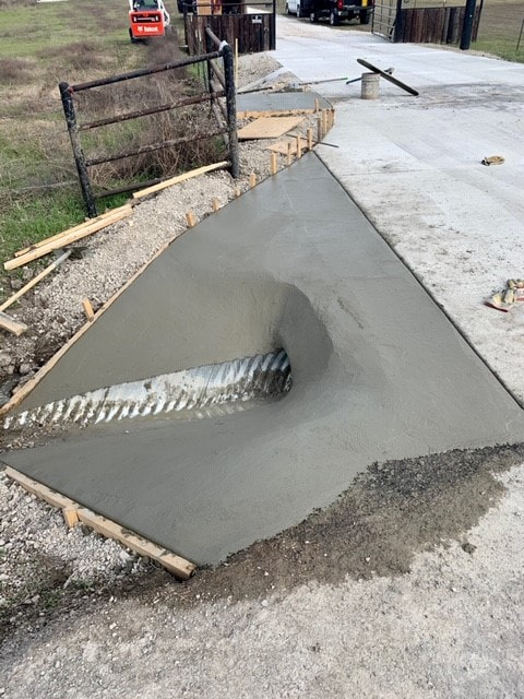 culvert drain pipe encased in fresh concrete