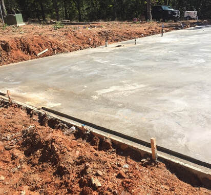 Image of freshly poured concrete foundation.