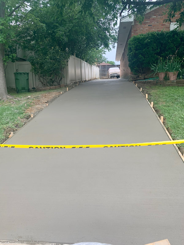 freshly poured concrete driveway curing