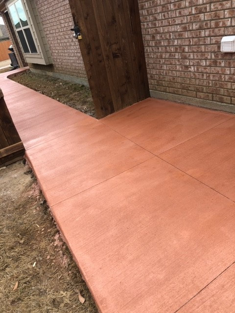 another close up view of stained concrete sidewalk going into backyard